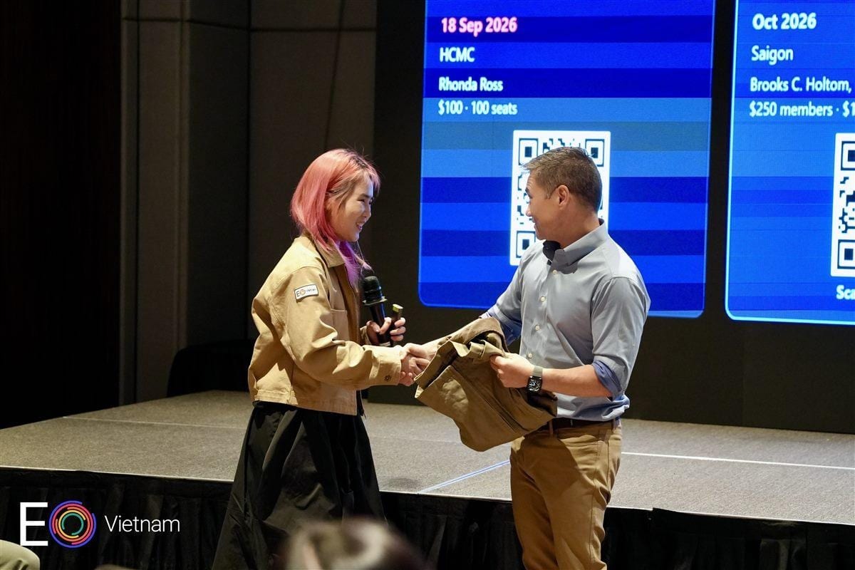Yen Do thanking Charles with a personalized EO jacket